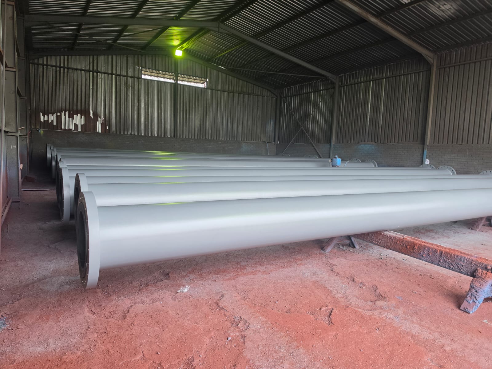 Coated HDPE-lined steel pipe lengths stored in the Wetpipe workshop